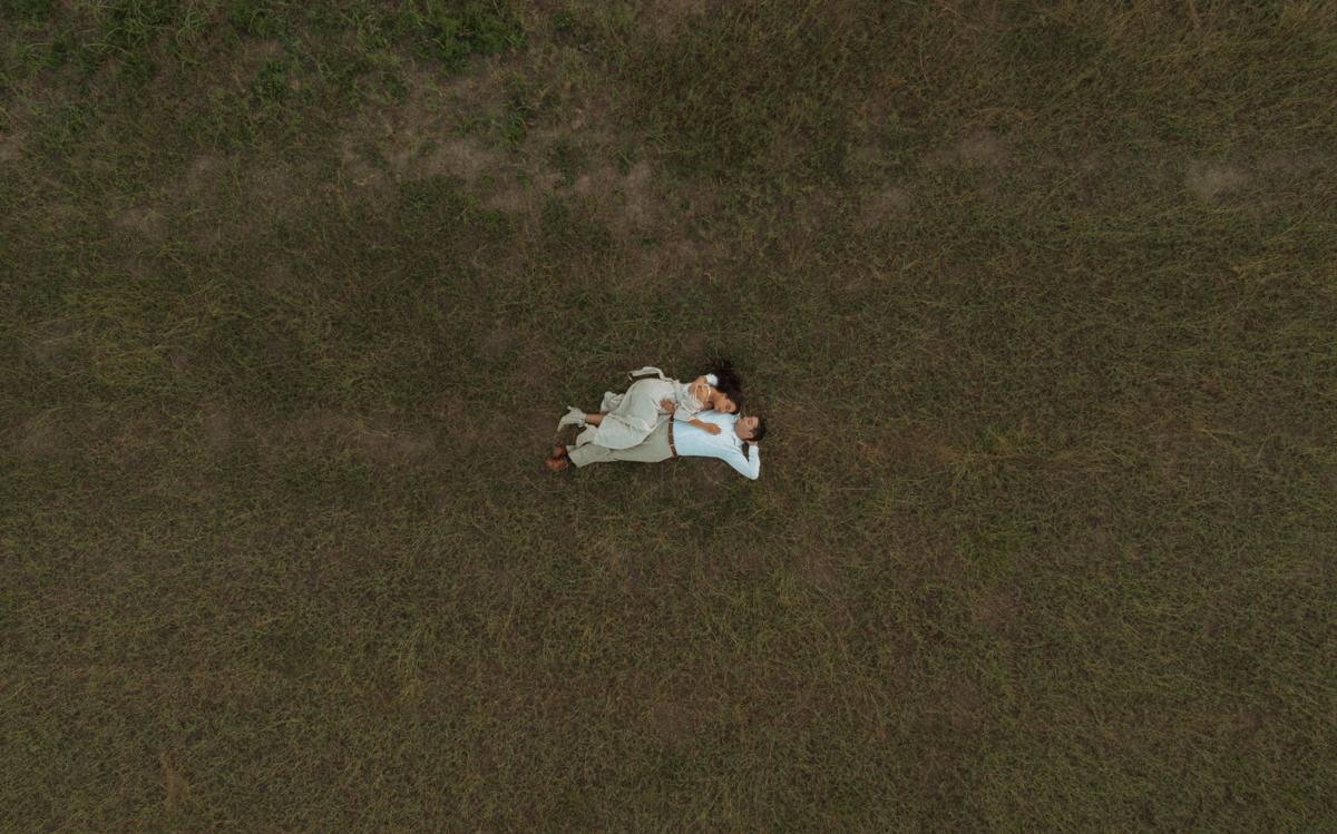 Jessica and Erick lying in a field